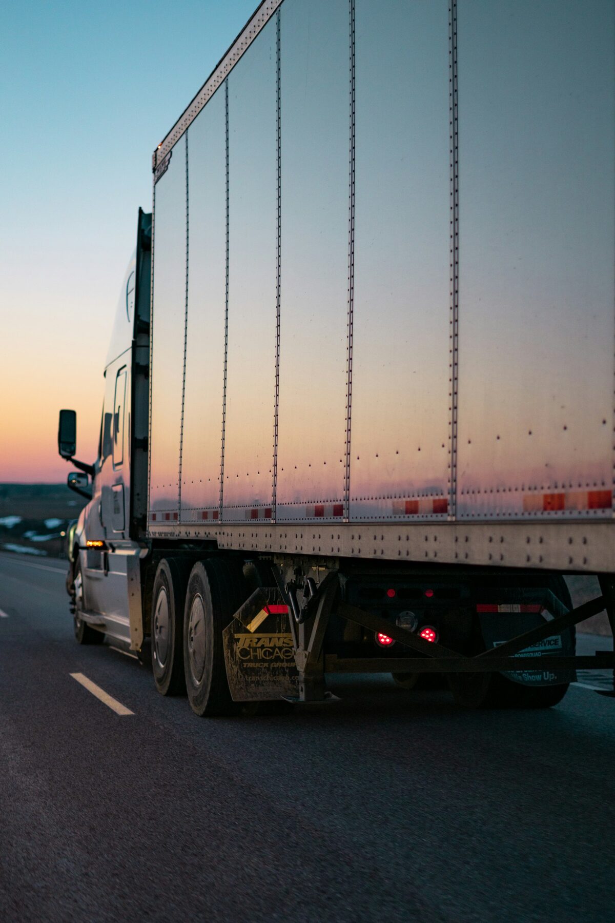 RAASO Trucking dry van on the highway at dusk