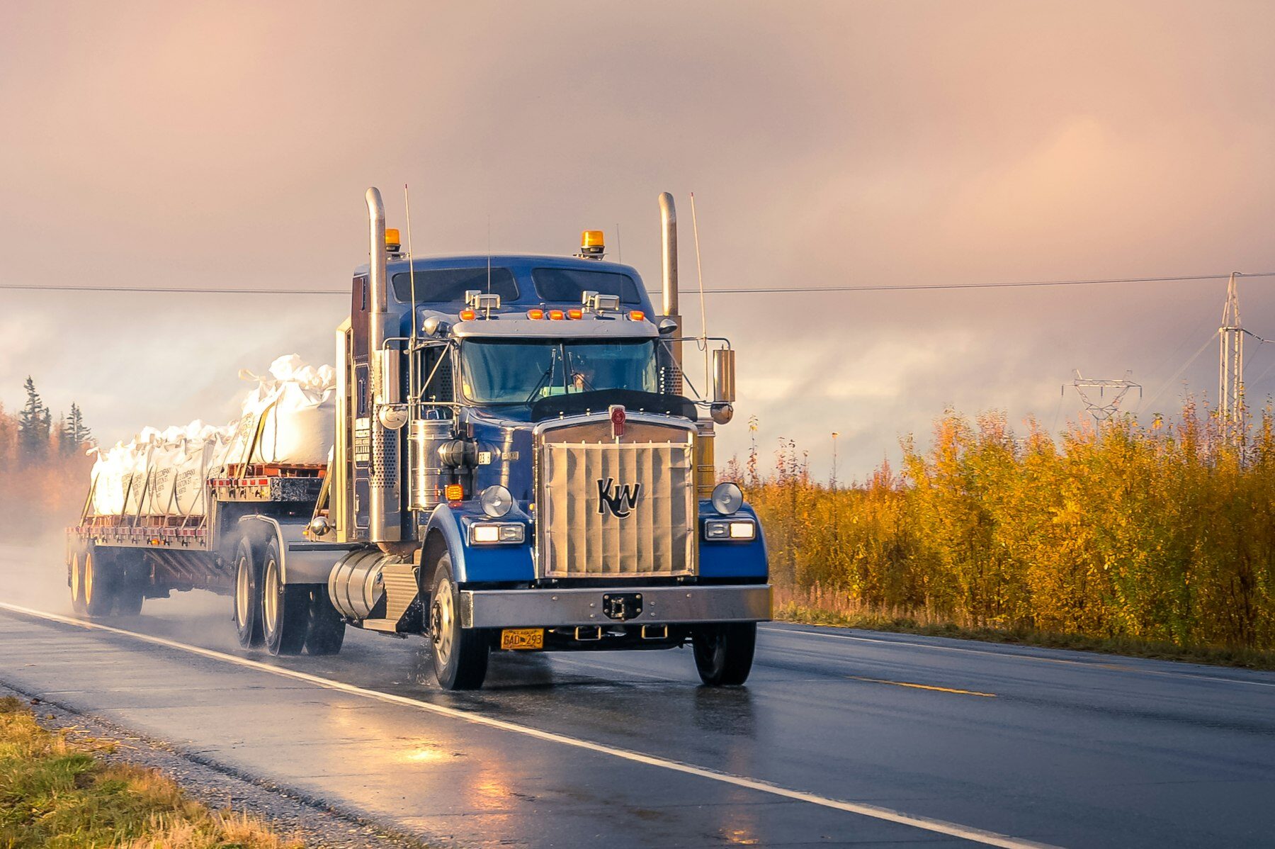 RAASO Trucking American semi on the highway at sunset