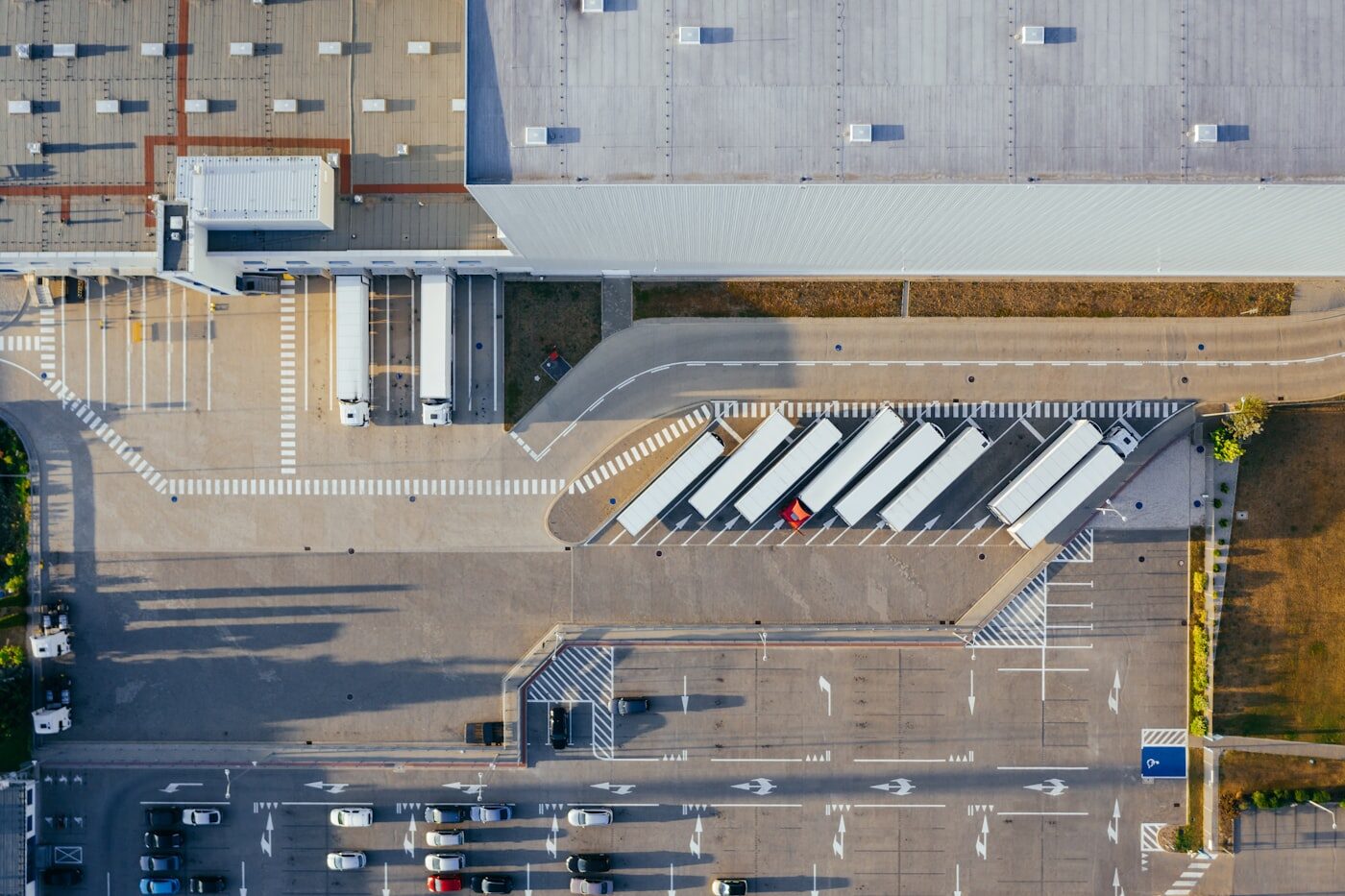 Aerial view of a distribution center with trucks at loading docks